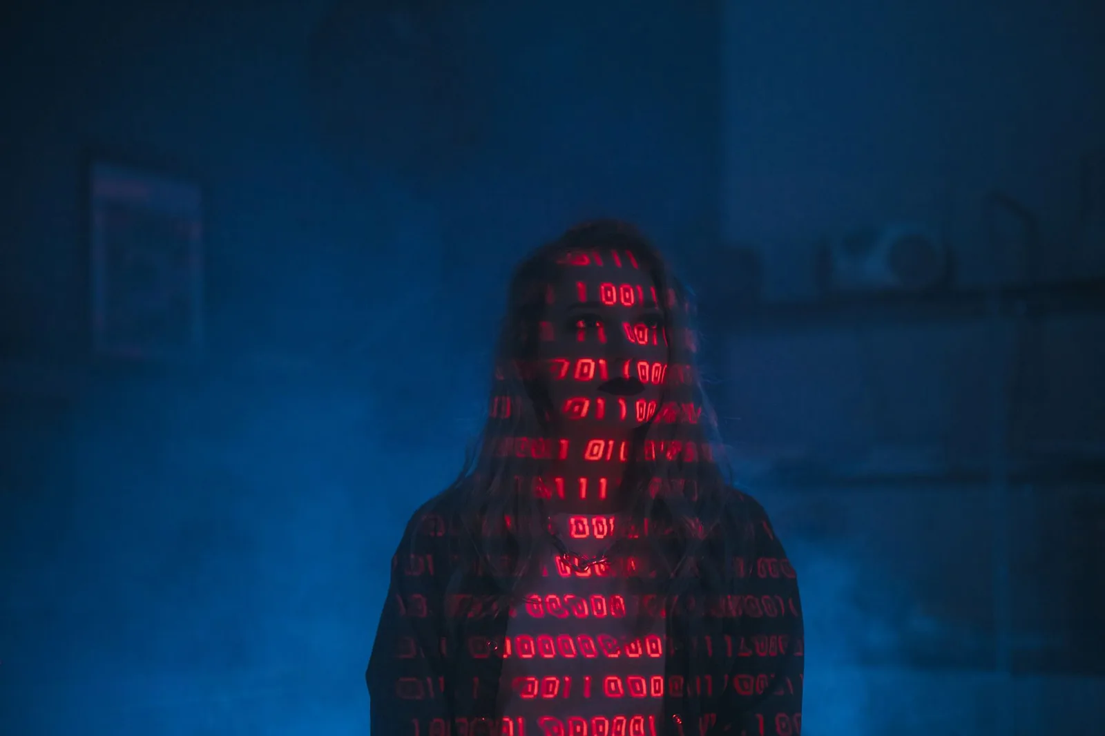 Best Agentic AI Security Tools in 2026 — A mysterious silhouette with red binary code projected over the face, set against a…