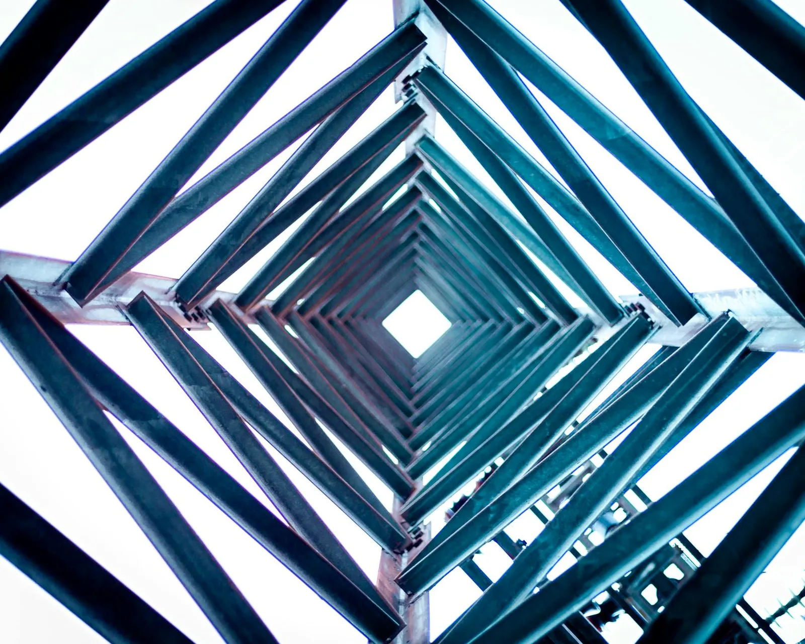 Building a Govern Program With a Team of 5 — Artistic view looking up through a geometric steel tower against a bright sky.