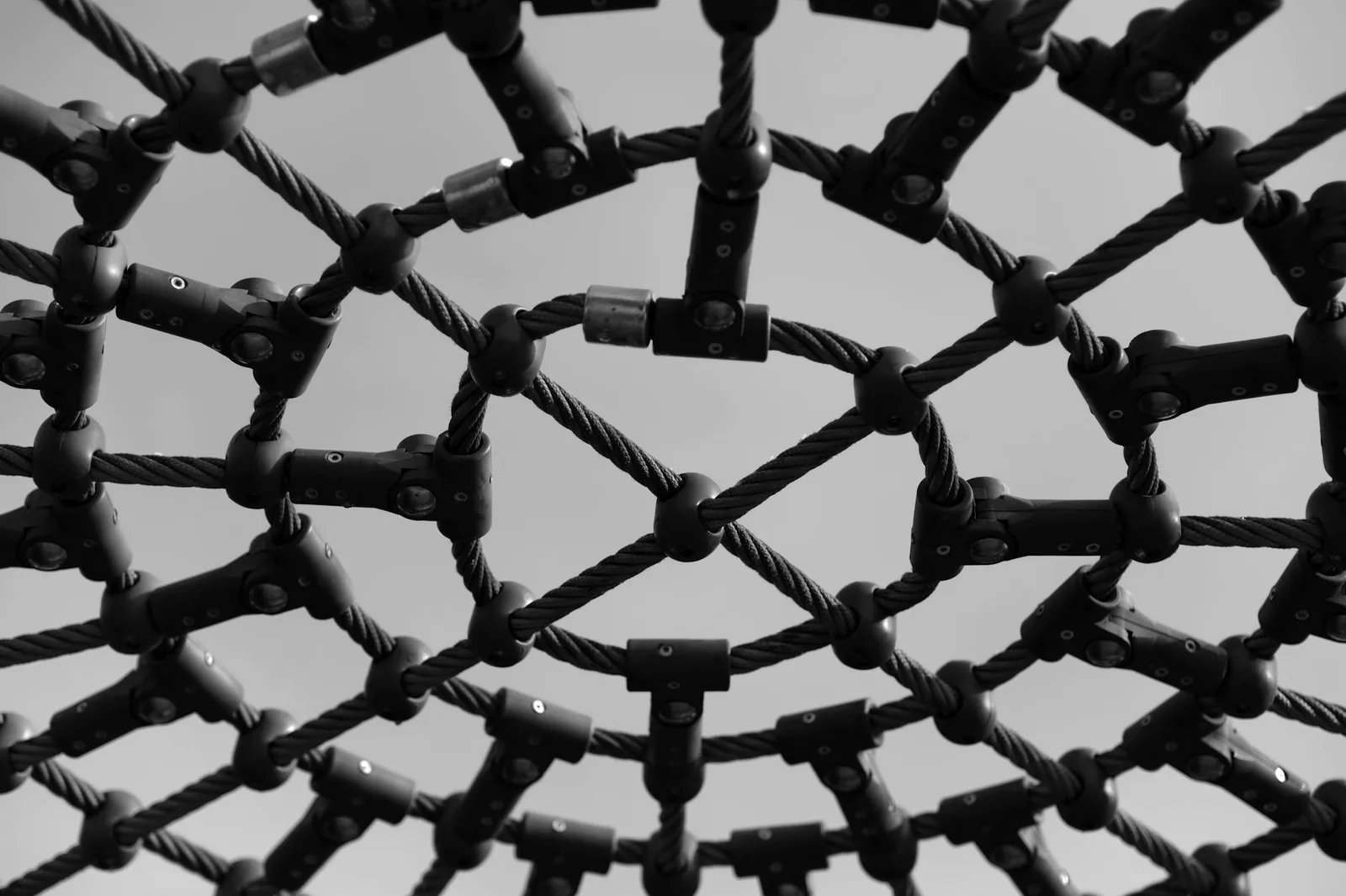 Building a Respond Program With a Team of 5 — Black and white close-up of an intricate playground climb structure showcasing…