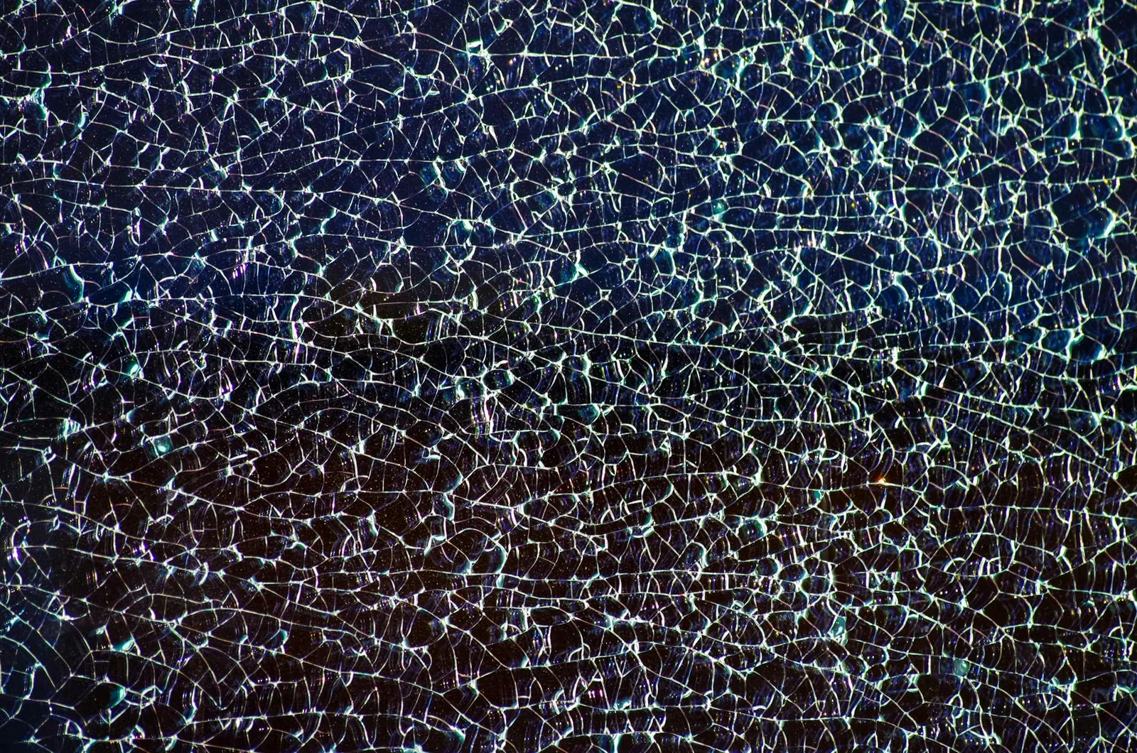 Conference Booths Do Not Close Deals Anymore — Abstract closeup of a colorful cracked glass surface, showcasing intricate fra…