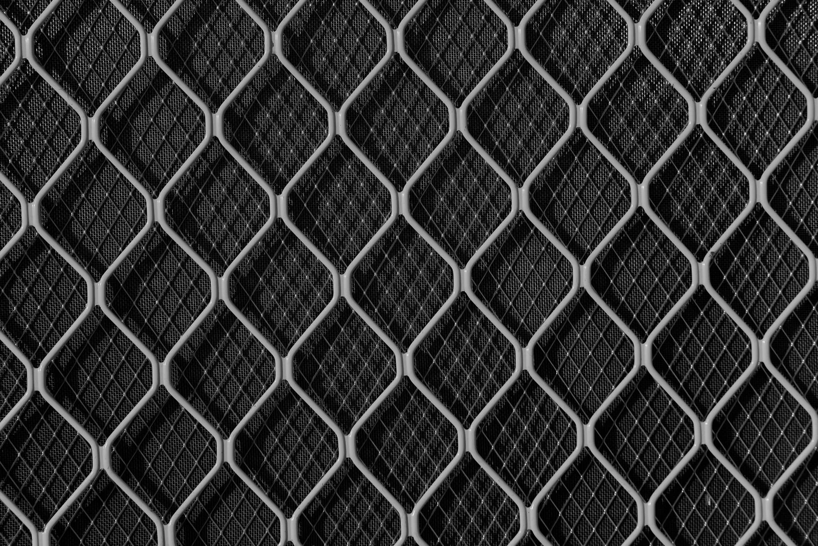 Best Dynamic Application Security Testing Tools in 2026 — Close-up view of a textured metal mesh grid creating an abstract ge…