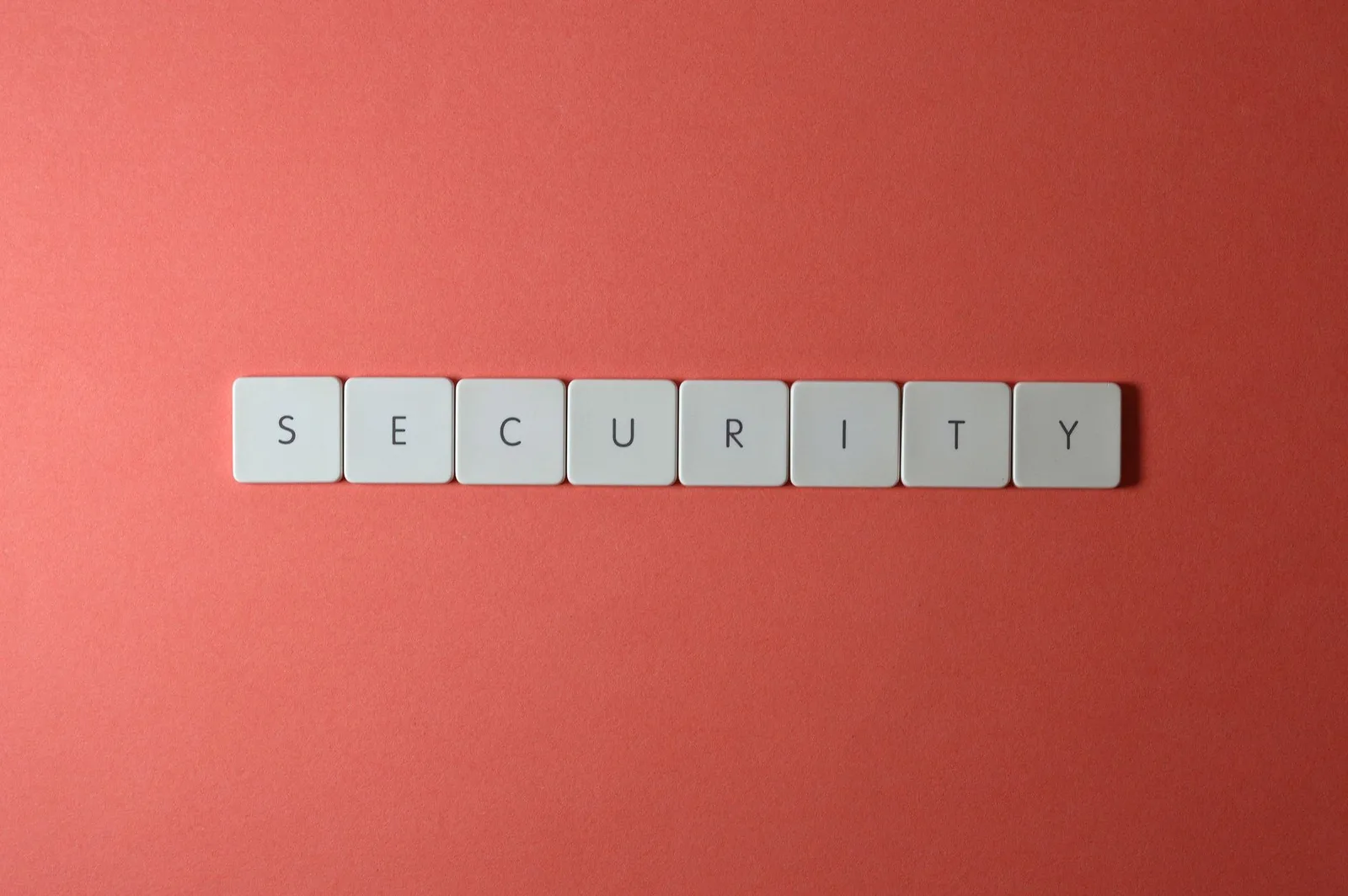 Best Database Security Tools in 2026 — A conceptual image of the word 'security' spelled with keyboard keys on a red surface,…