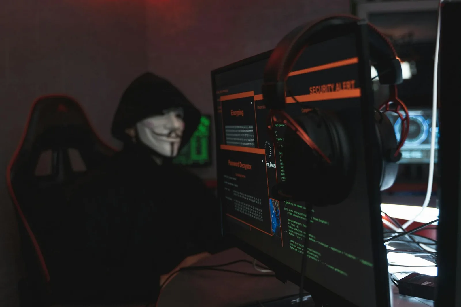 Best Endpoint Security Tools in 2026: Top 8 Compared — A person wearing a Guy Fawkes mask engaged in hacking activities on a…
