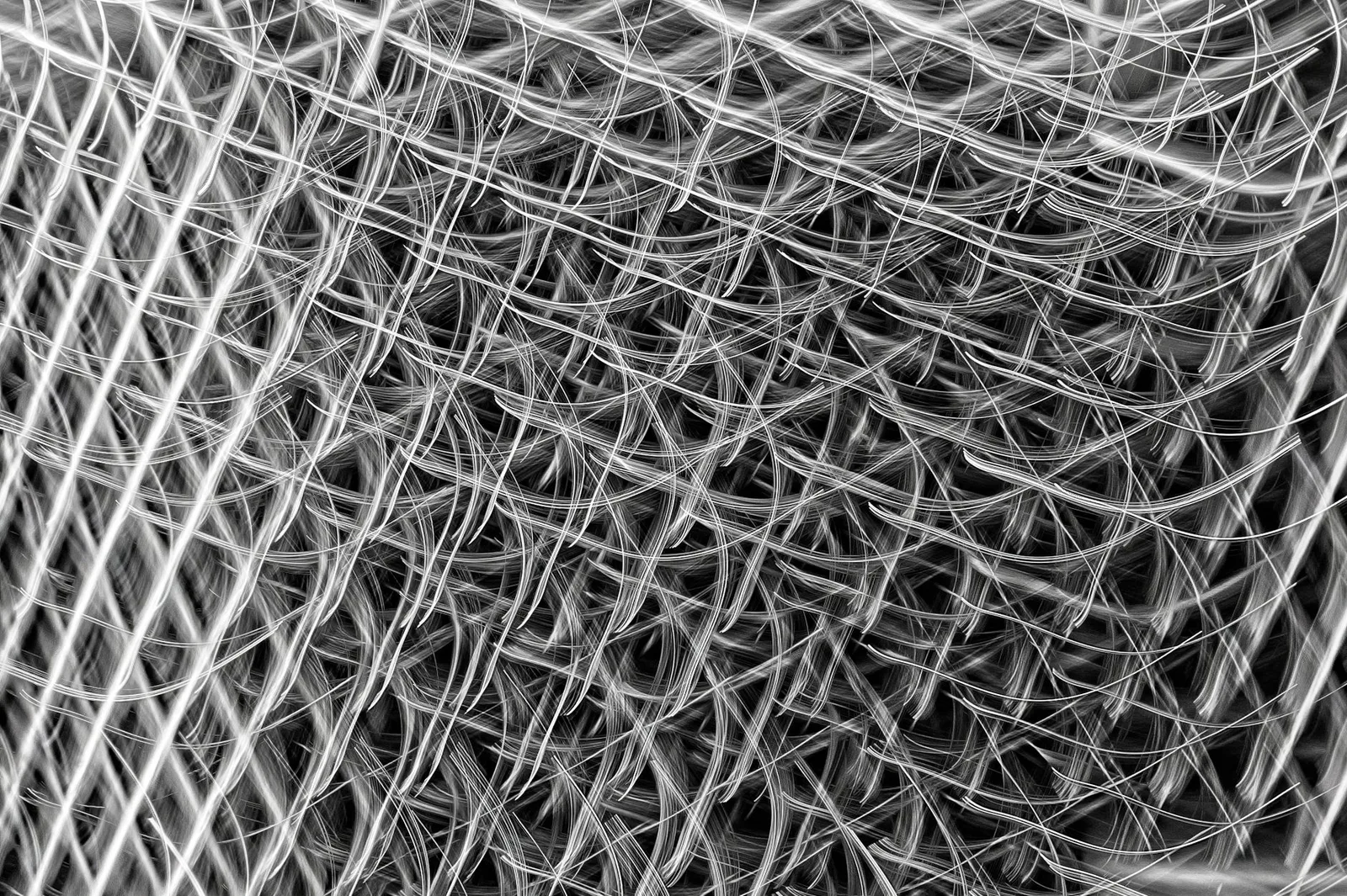 Best Privileged Access Management Tools in 2026 — Complex lattice of interwoven metallic wires creating a modern abstract tex…