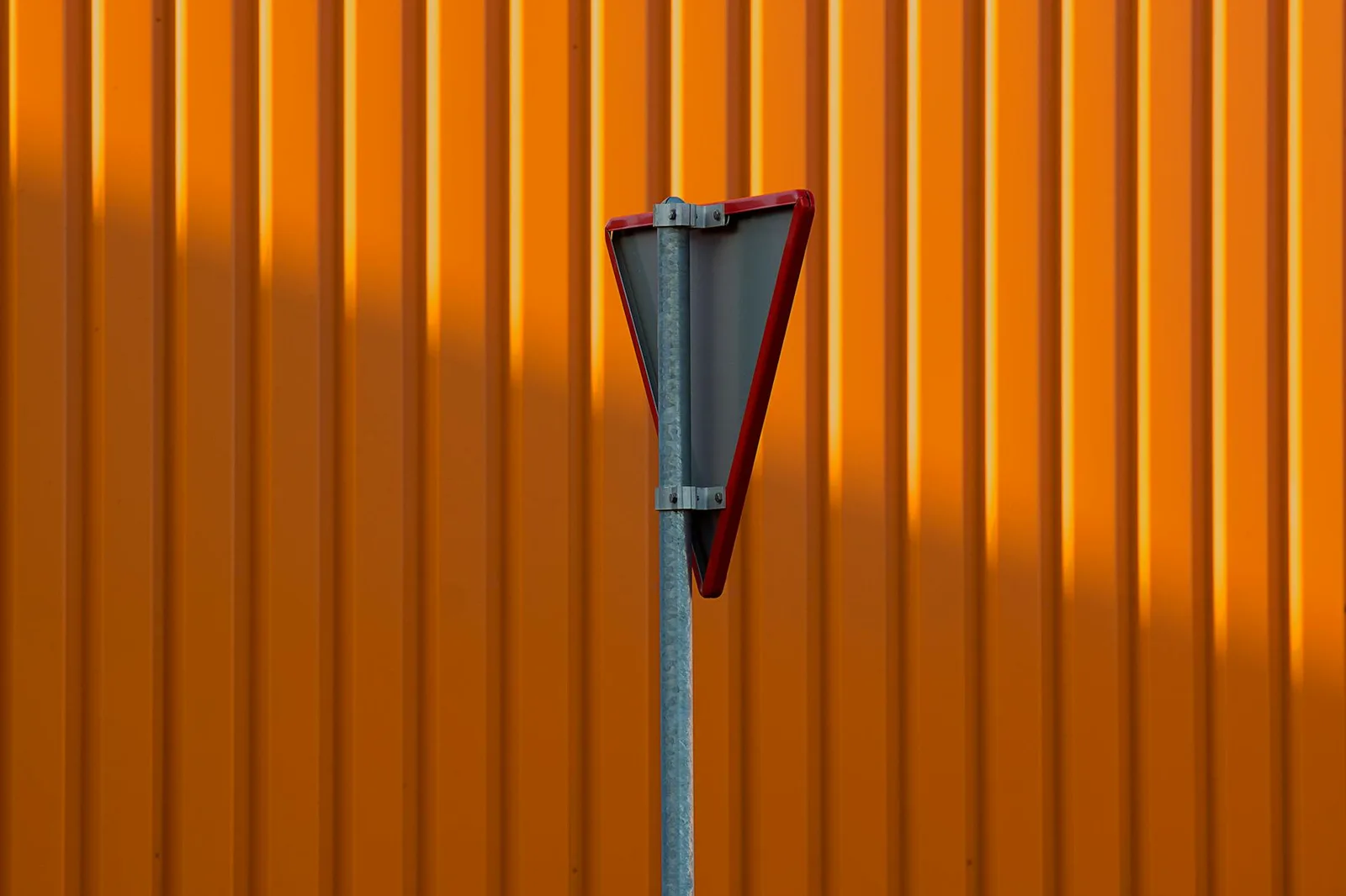 7 Things on Your Homepage That Make CISOs Close the Tab — Back view of a triangular traffic sign against a vibrant orange cor…