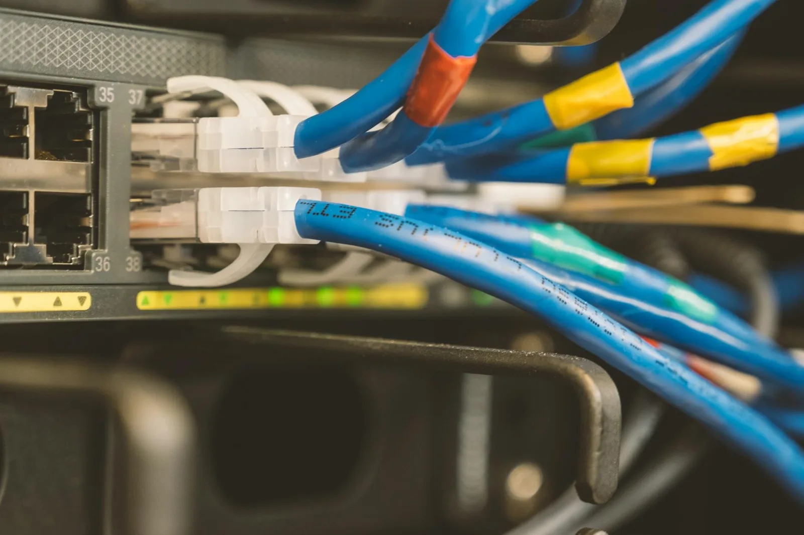 Trust Over Authority: Why the New CISO Asks Their Team, Not Gartner — Network switch and blue ethernet cable with white tips…